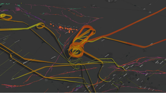 3D visualization of aircraft flight paths and their altitudes expressed in multi-dimensions with a series of red, green, and orange connected lines 