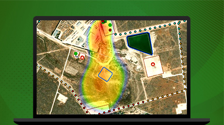 A graphic of a laptop displaying an aerial photo of a factory overlaid with a heat map layer in orange and yellow