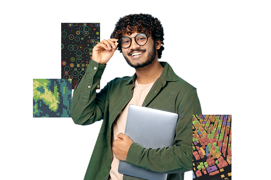 Ein junger Mann mit Brille und in grünem Hemd, der einen silbernen Laptop hält