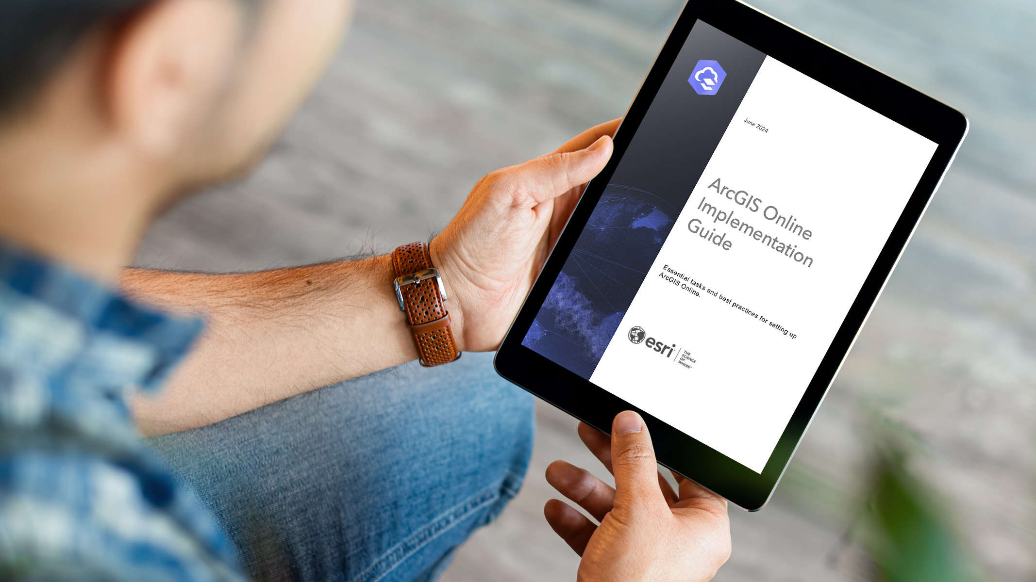 Eine Person liest den "ArcGIS Online Implementation Guide" auf einem Tablet
